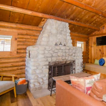 Cottage living room with a river-rock fireplace